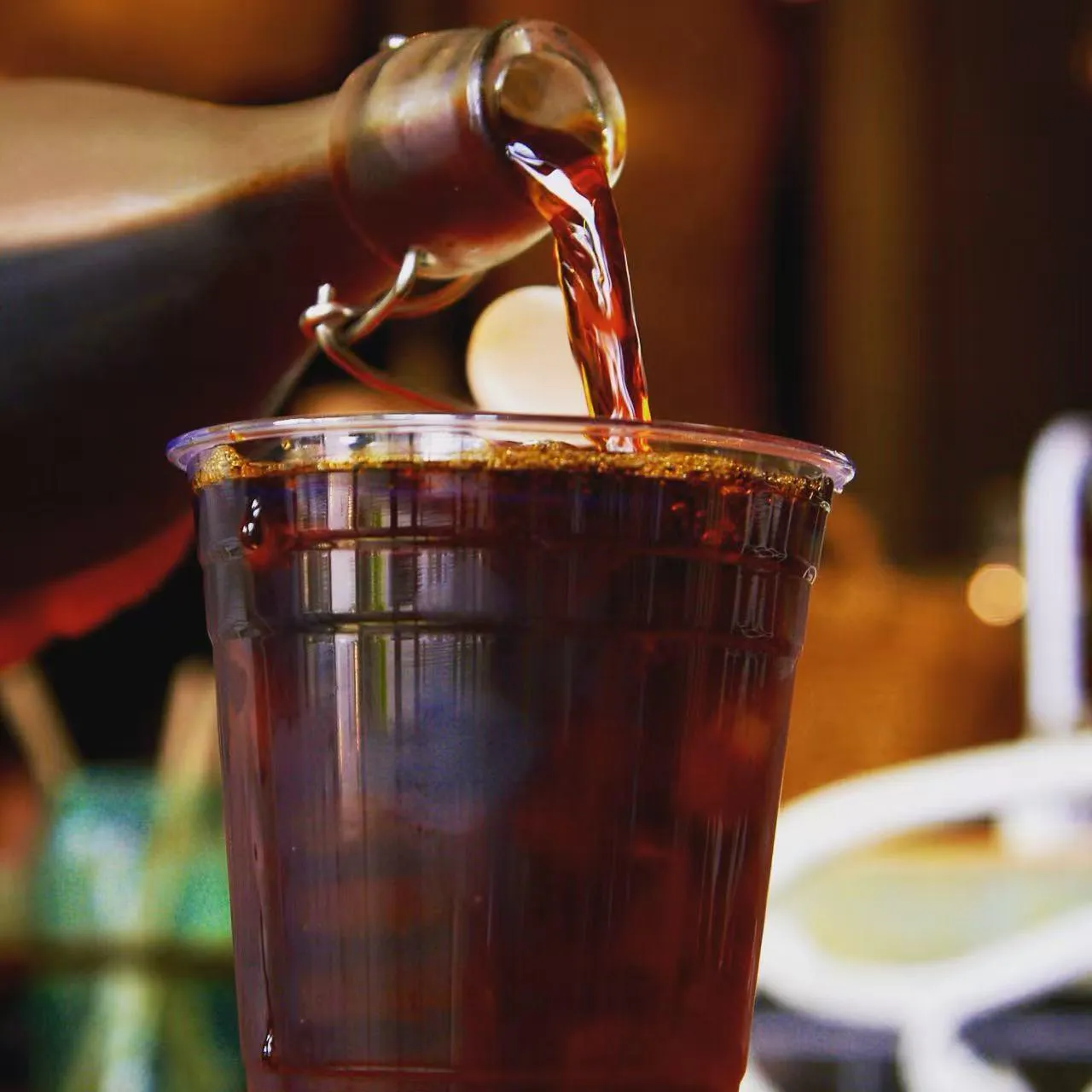 Cold brew coffee being poured into a clear cup at Rise & Grind Cafe, a Coffee Shop in Los Angeles